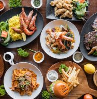 Top looking down at restaurant food spread on table.